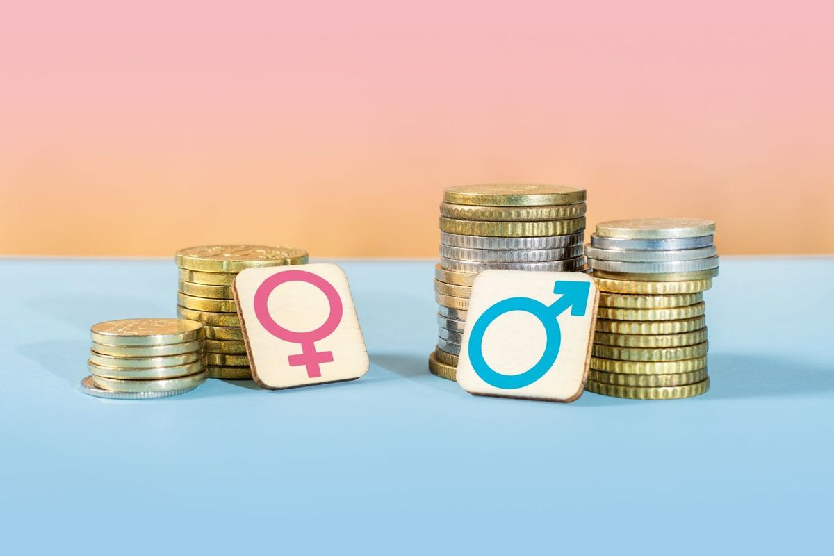 Two piles of coins with gender symbols in front. The women's symbol has a much smaller amount of coins with it than the men's.
