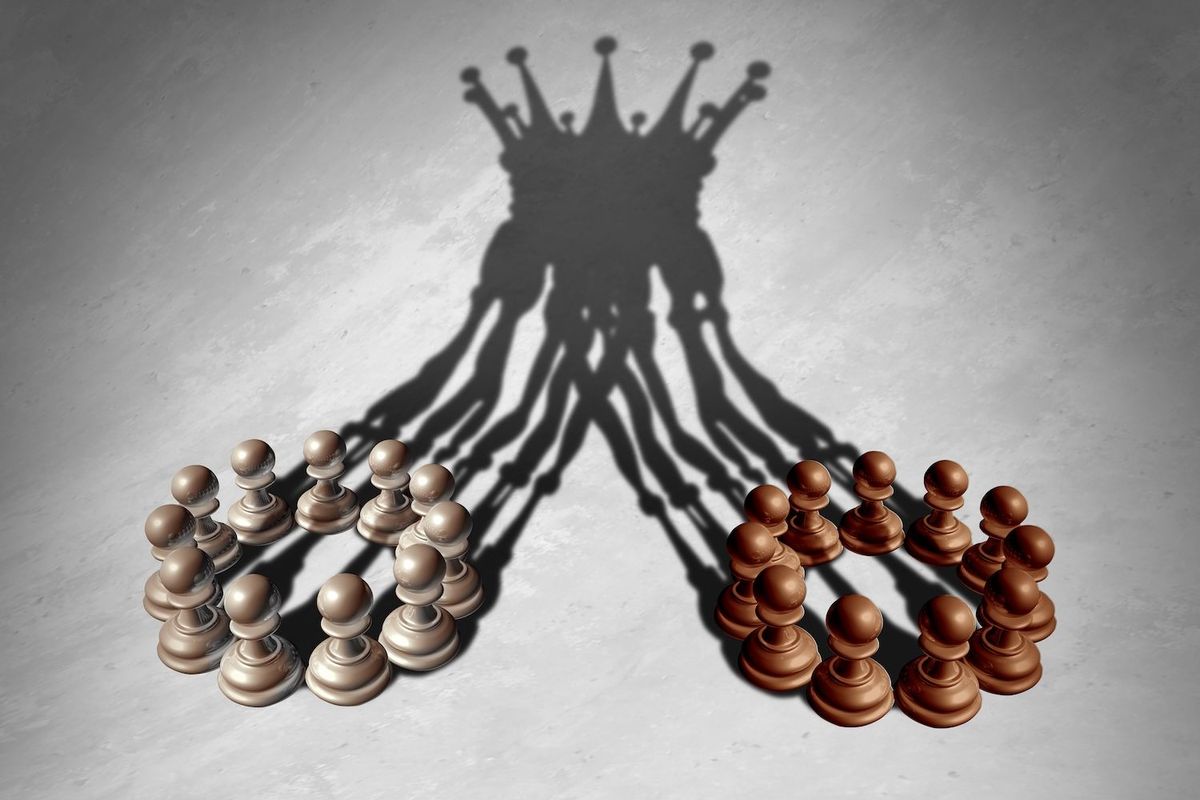 Two sets of chess pieces coming together.