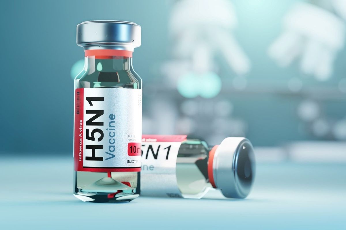 Two vials labelled "H5N1 Vaccine." One stands and one lays on its side behind the first.