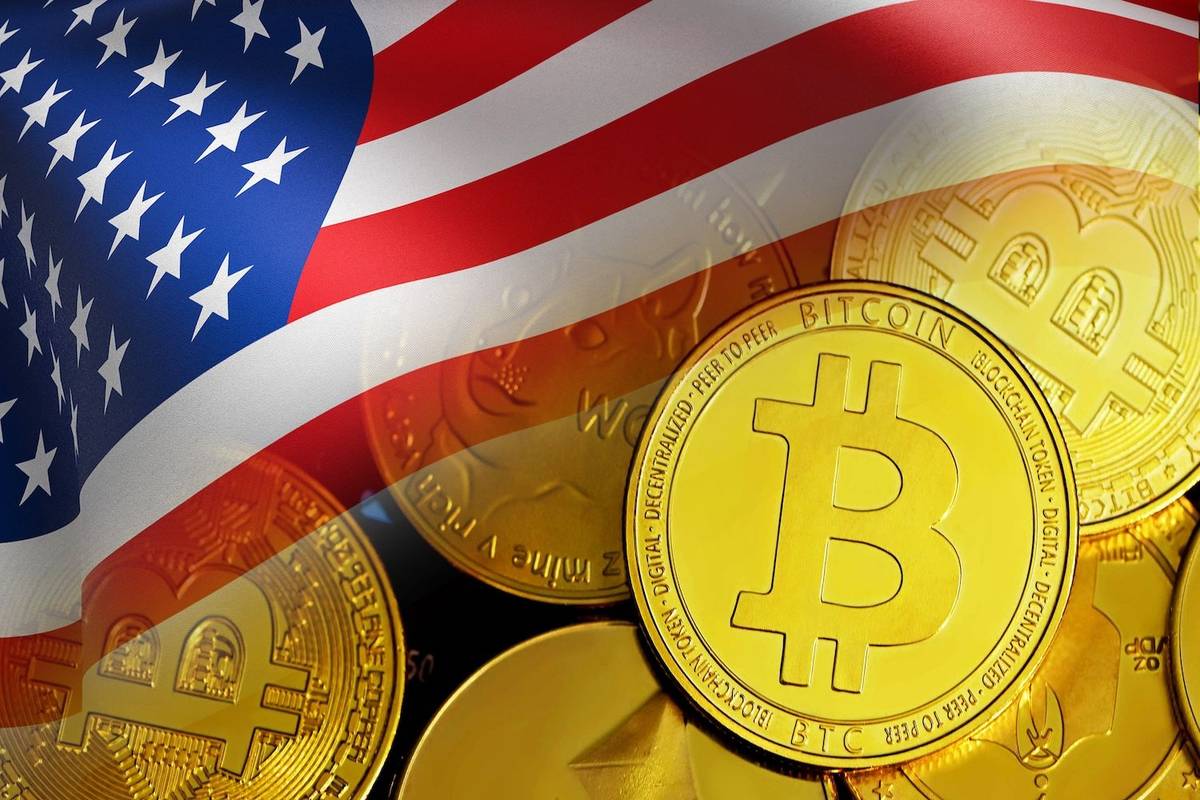 U.S. flag waves over multiple golden Bitcoin coins, text reads: Bitcoin, blockchain token, digital, decentralized, peer to peer.