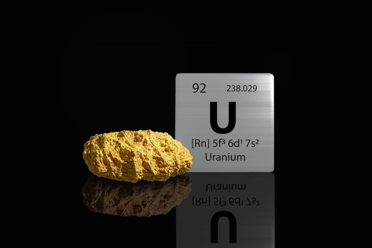 Uranium ore with uranium periodic symbol.