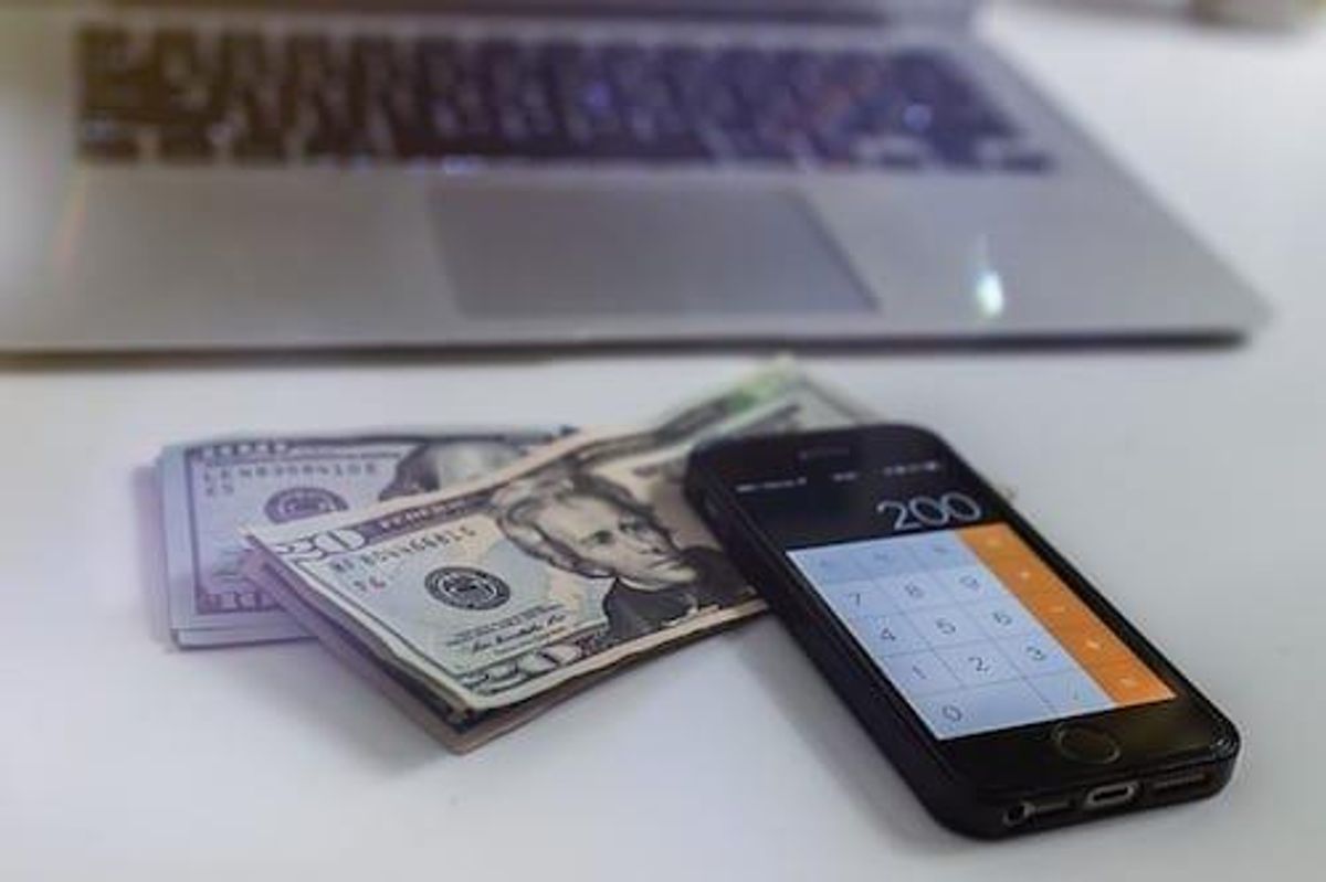 US$20 bills with calculator