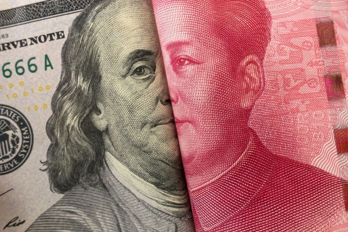 US dollar and Chinese yuan bills merged, showing both leaders' portraits.