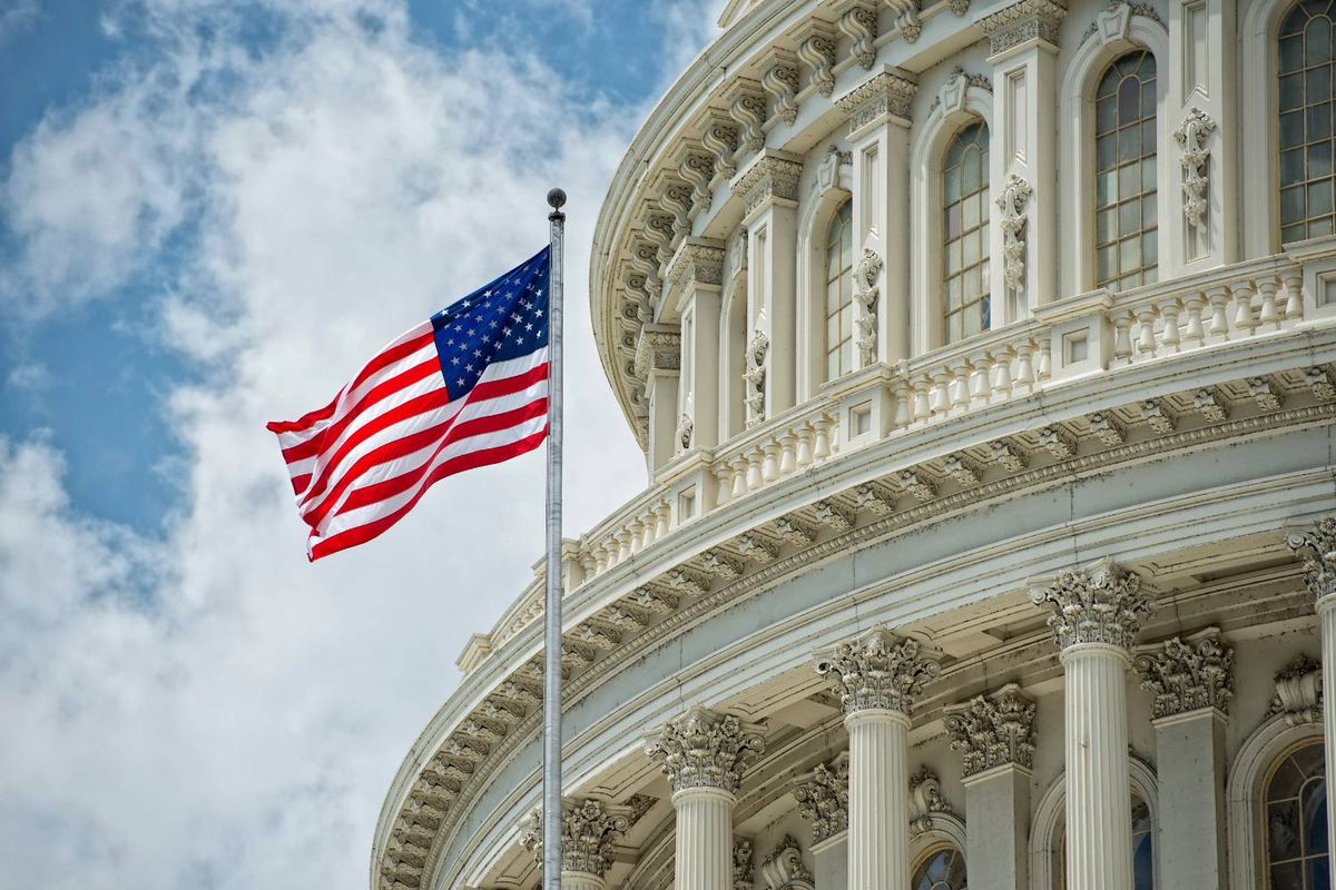 US flag waves in front of the Capitol building in Washington, DC.