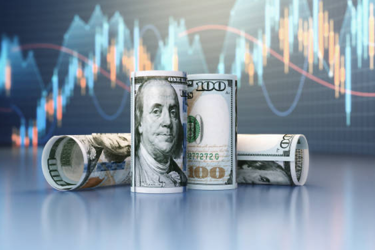 US money with stock chart in background.