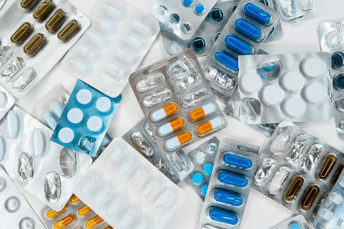 Various blister packs with pills and capsules in different colors and shapes.