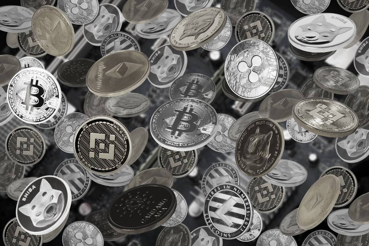Various silver cryptocurrency coins with logos float over a blurred background.