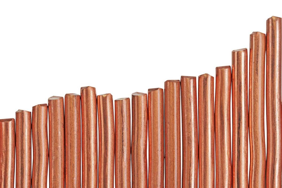 Vertical copper sticks arranged unevenly in a row, on a white background.