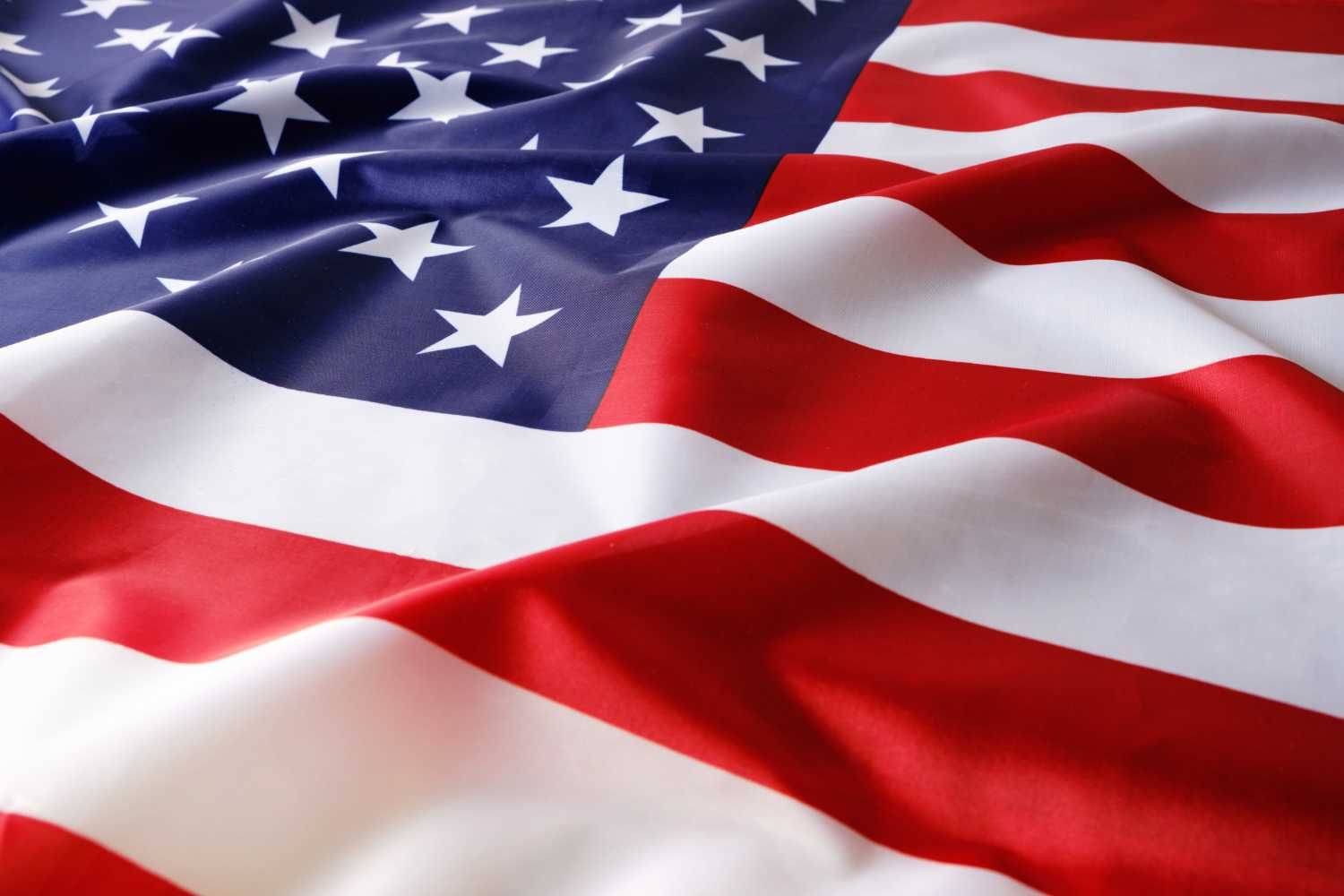 Waving American flag with stars and stripes.