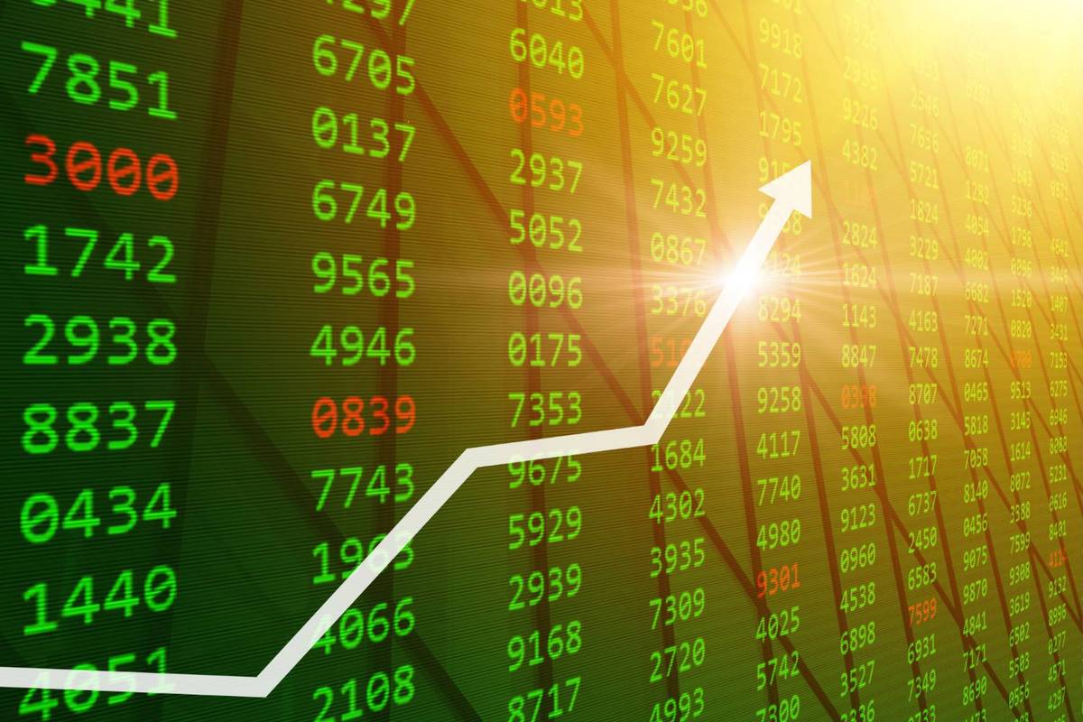 White arrow rises over a green and red financial stock market display with sunlit numbers.