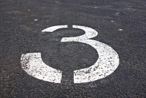 white number 3 painted on asphalt