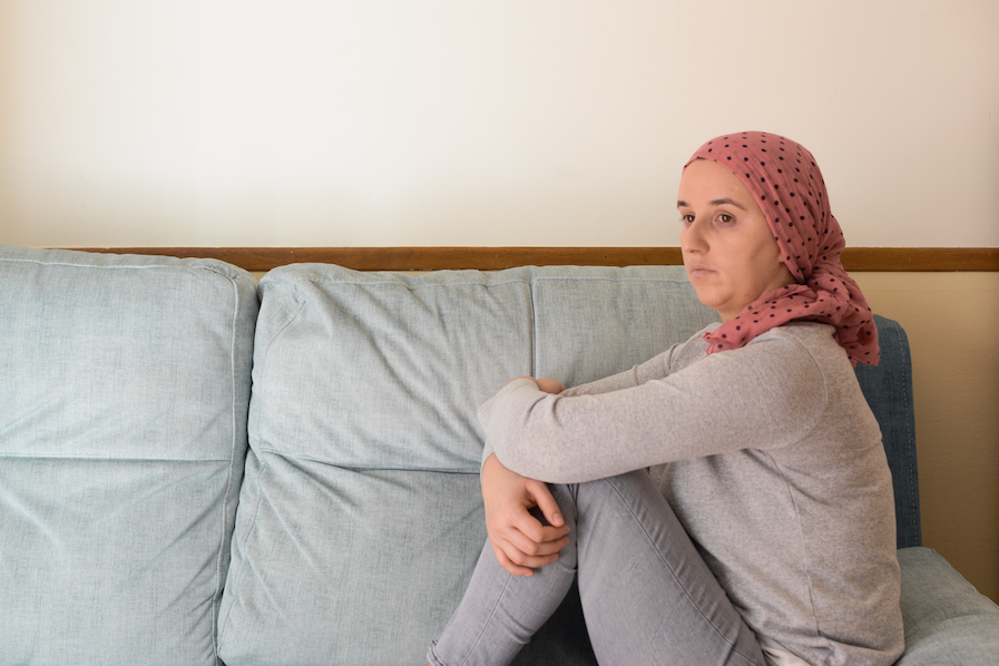 woman in headscarf sitting on couch