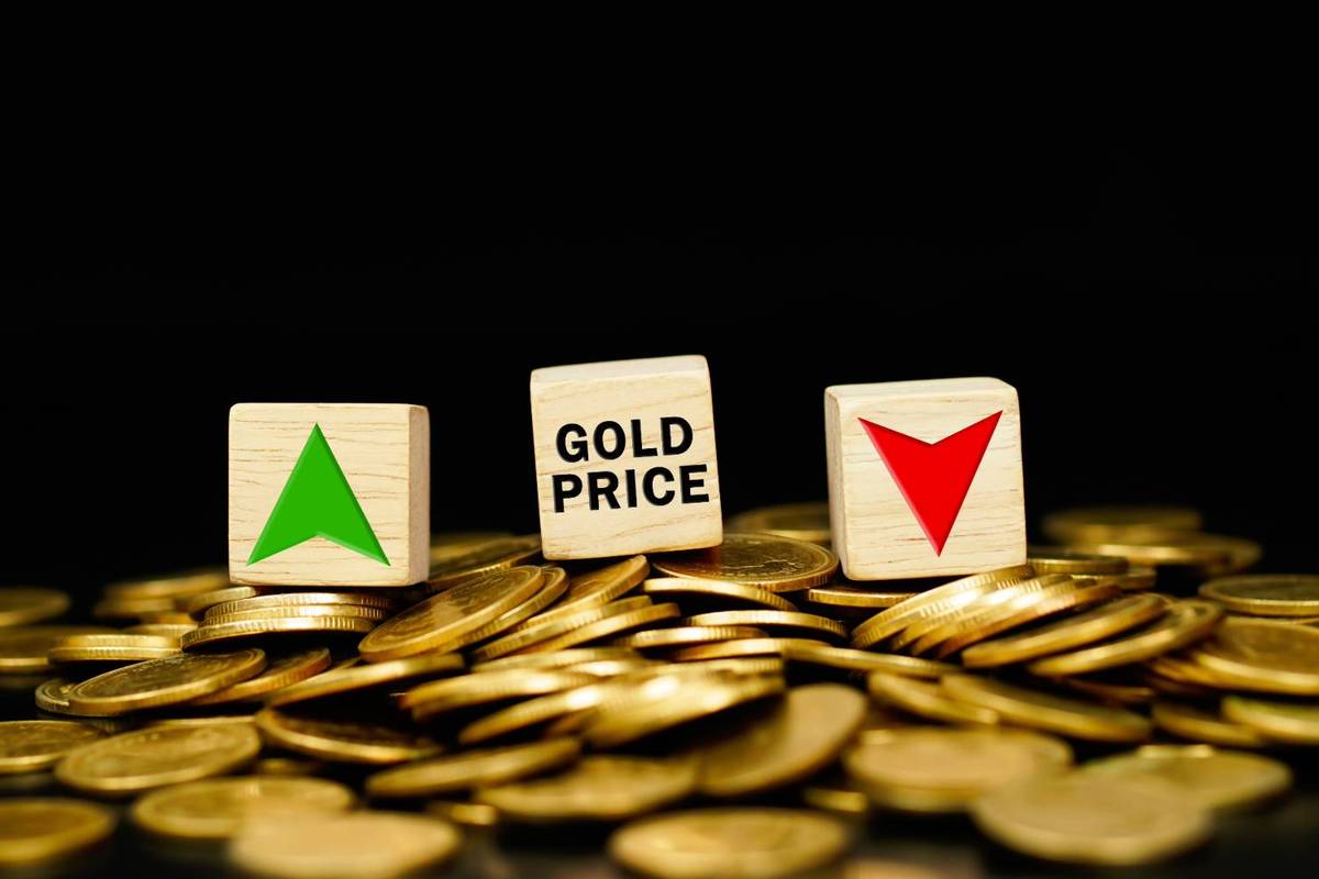 Wooden blocks with arrows and "GOLD PRICE" text sit on piles of gold coins against a black background.