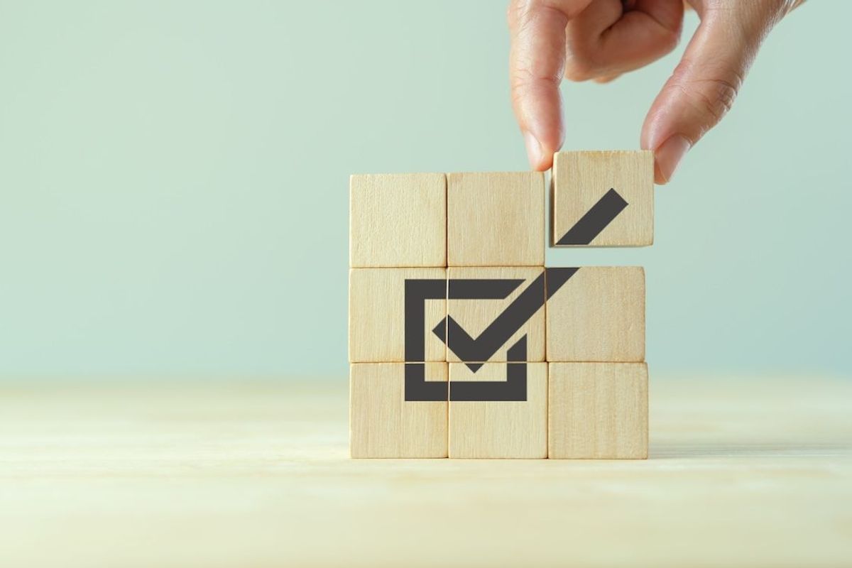 Wooden blocks with check mark on them.