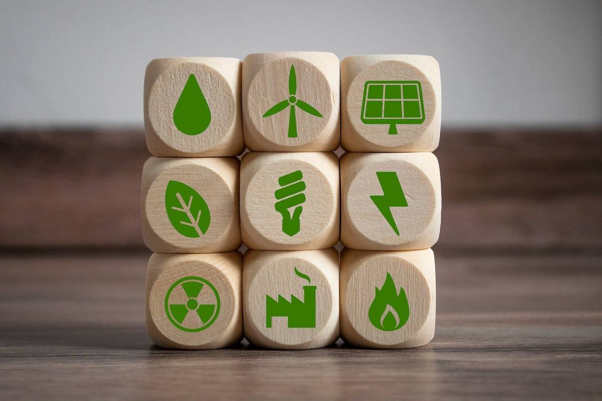 Wooden blocks with green energy and sustainability icons.