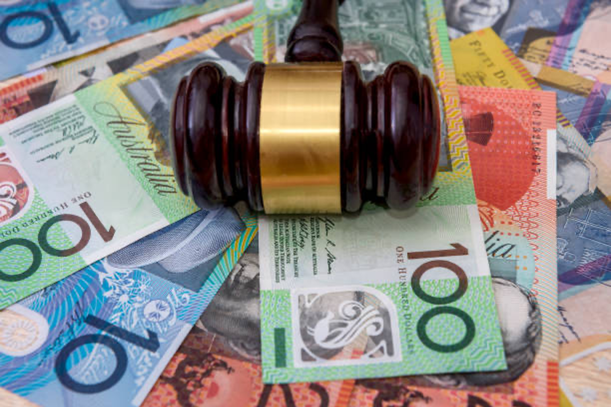 Wooden gavel on australian dollar bills.