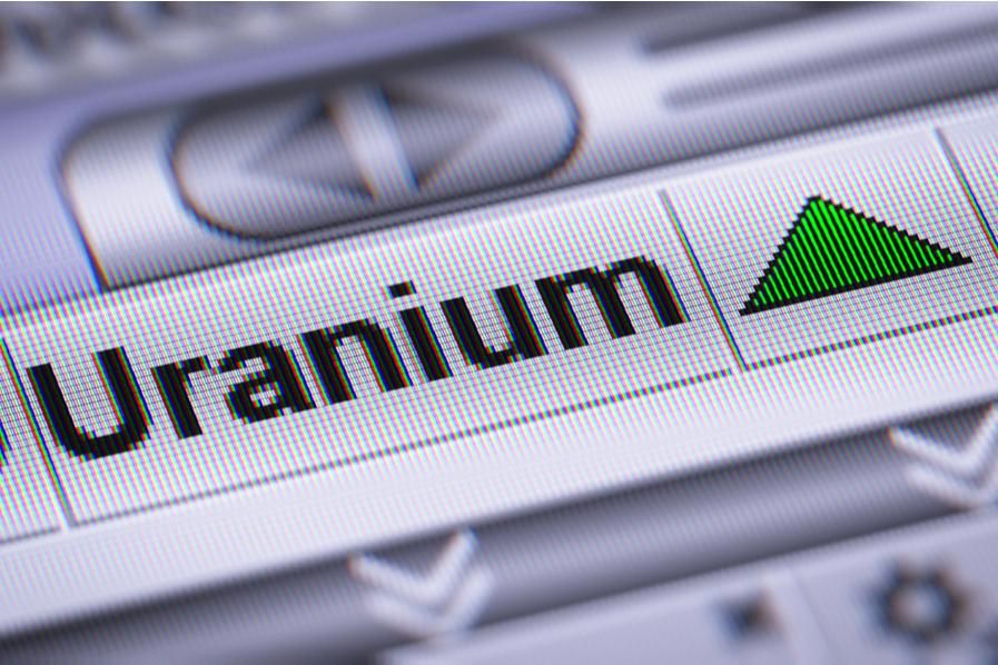 word uranium with a green arrow pointing up on a screen