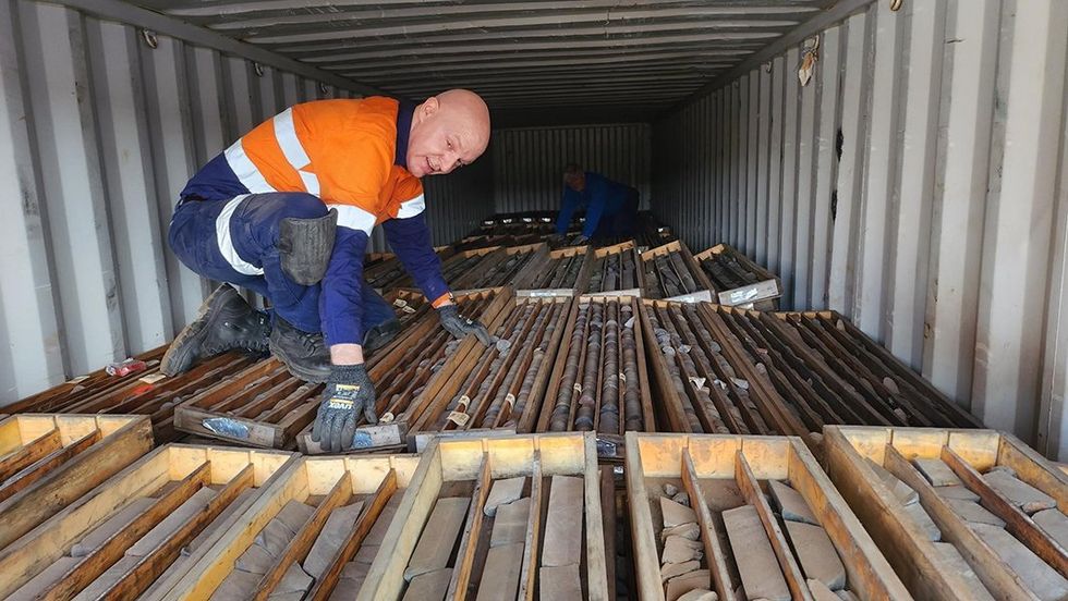 Worker inspecting core from Iron Bear project site