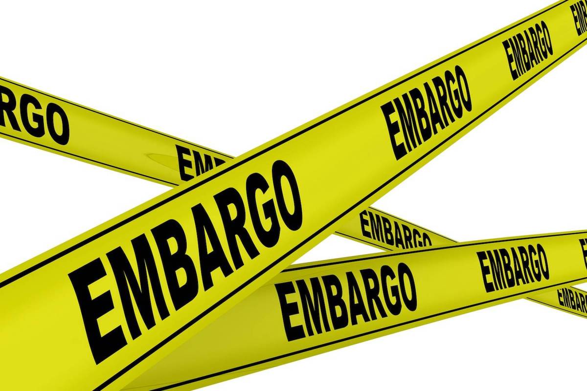 Yellow tape with "EMBARGO" in bold black letters, crisscrossing.