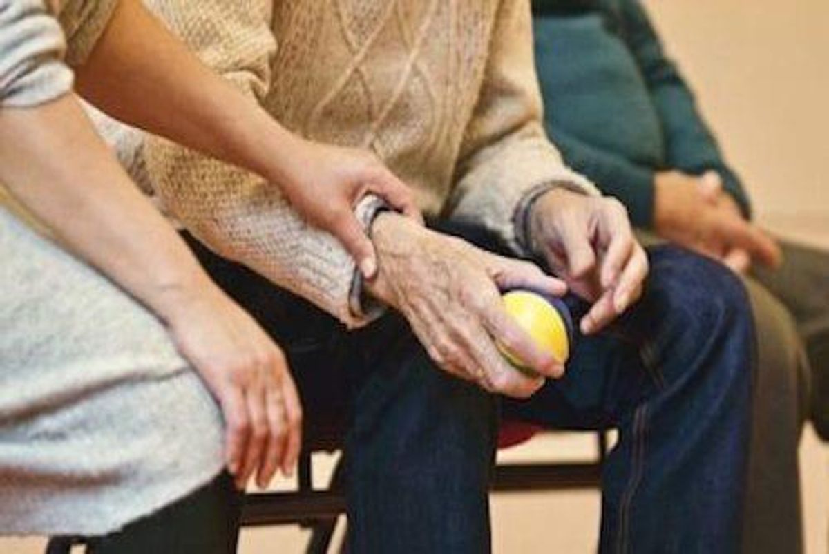 younger person holding hand of older person
